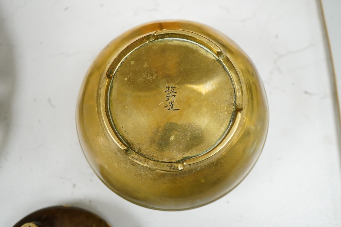 A Chinese bronze censer with gilt splashed decoration, signed with character marks to the base, together with another gilt censer, largest 12cm in diameter